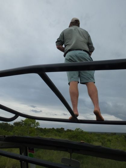 Simon standing on the roof frame looking for the cheetah. 